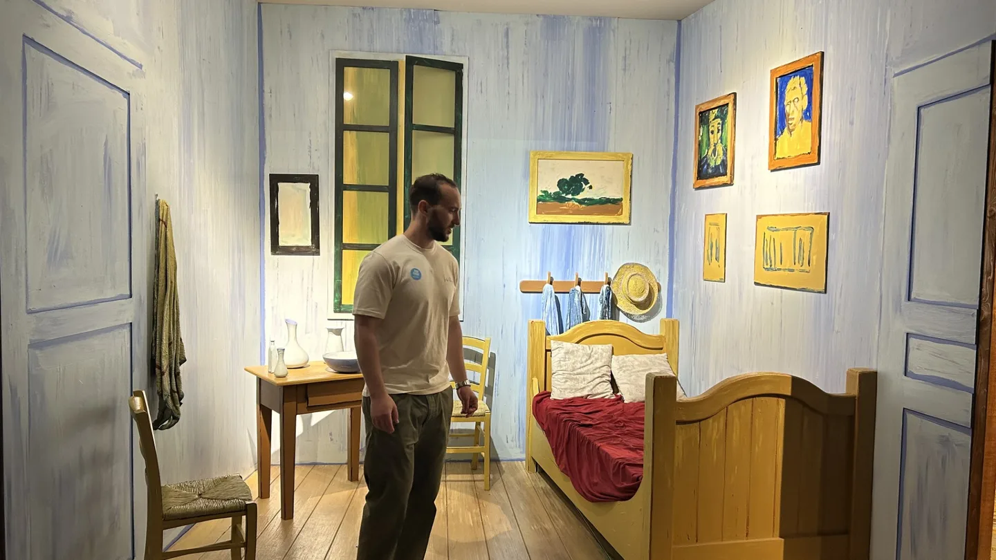 Marti standing in a life-size recreation of Van Gogh's bedroom in Arles